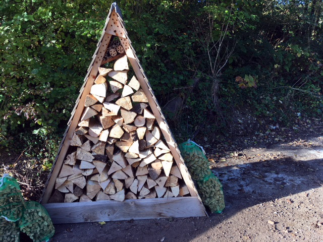 Triangular log store with bug hotel - Forest to Fire, West Dean, Chichester
